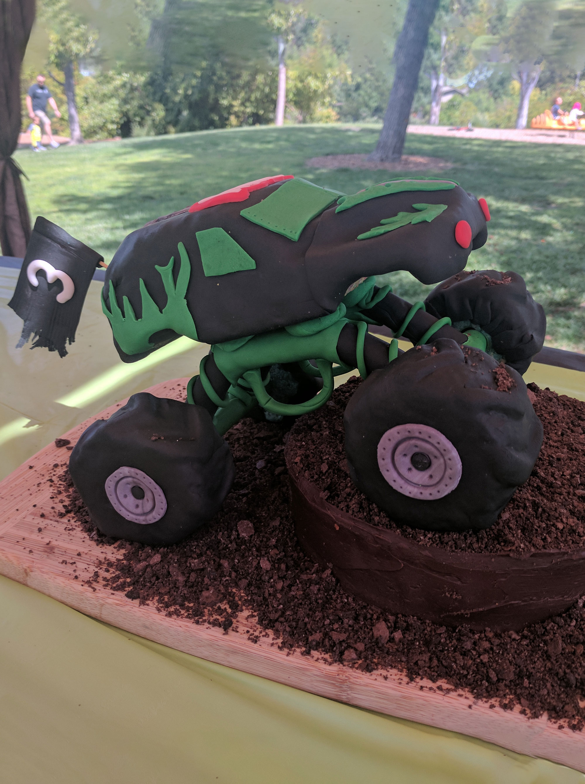 cake in the shape of a monster truck resembling grave digger